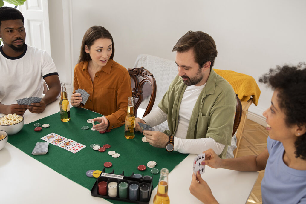 A group of friends gathered around a table, laughing and playing board games, with colorful cards and game pieces scattered around.