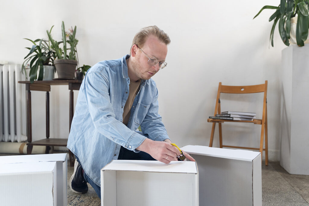 A person assembling a wooden shelf, focused and enjoying the process of creating something by hand.