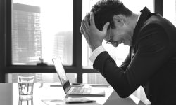 Stressed young businessman overworking
